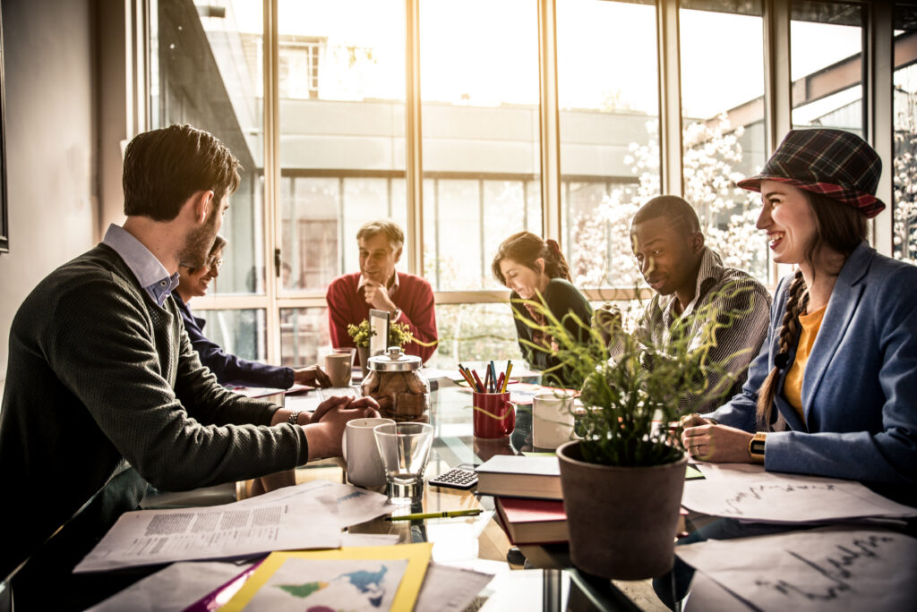 A group of professionals discussing leadership styles in the workplace and their effectiveness